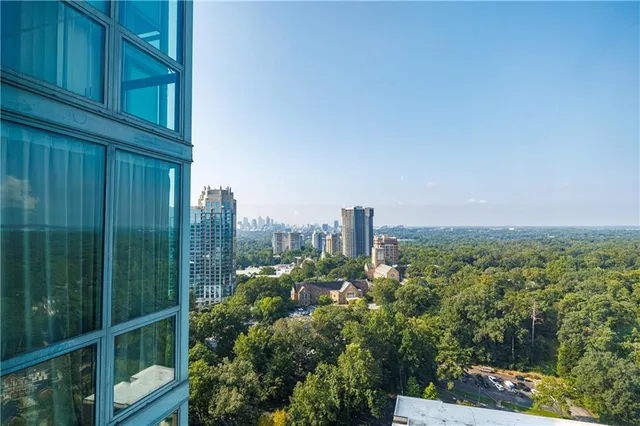 a bedroom with a bed and a flat tv screen on dresser
