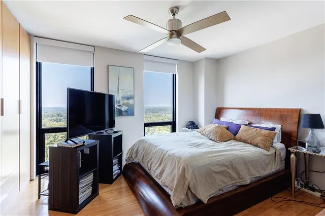 a bedroom with a bed and a television