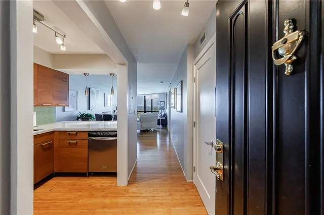 a kitchen with stainless steel appliances granite countertop a refrigerator and a sink