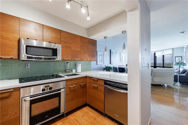 a kitchen with stainless steel appliances granite countertop a sink and a microwave