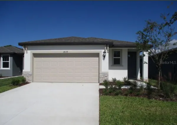 a front view of a house with a yard and garage