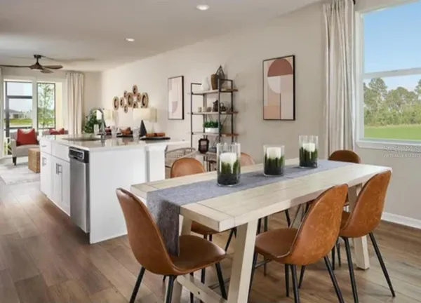 a dining room with furniture and wooden floor