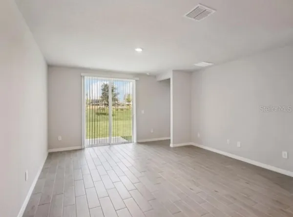 a view of an empty room with a window