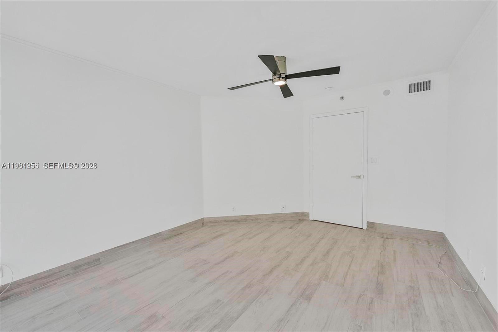 8911 Collins Avenue, Unit 703 Surfside, FL 33154 - Photo 13 of 24 a view of a room with wooden floor
