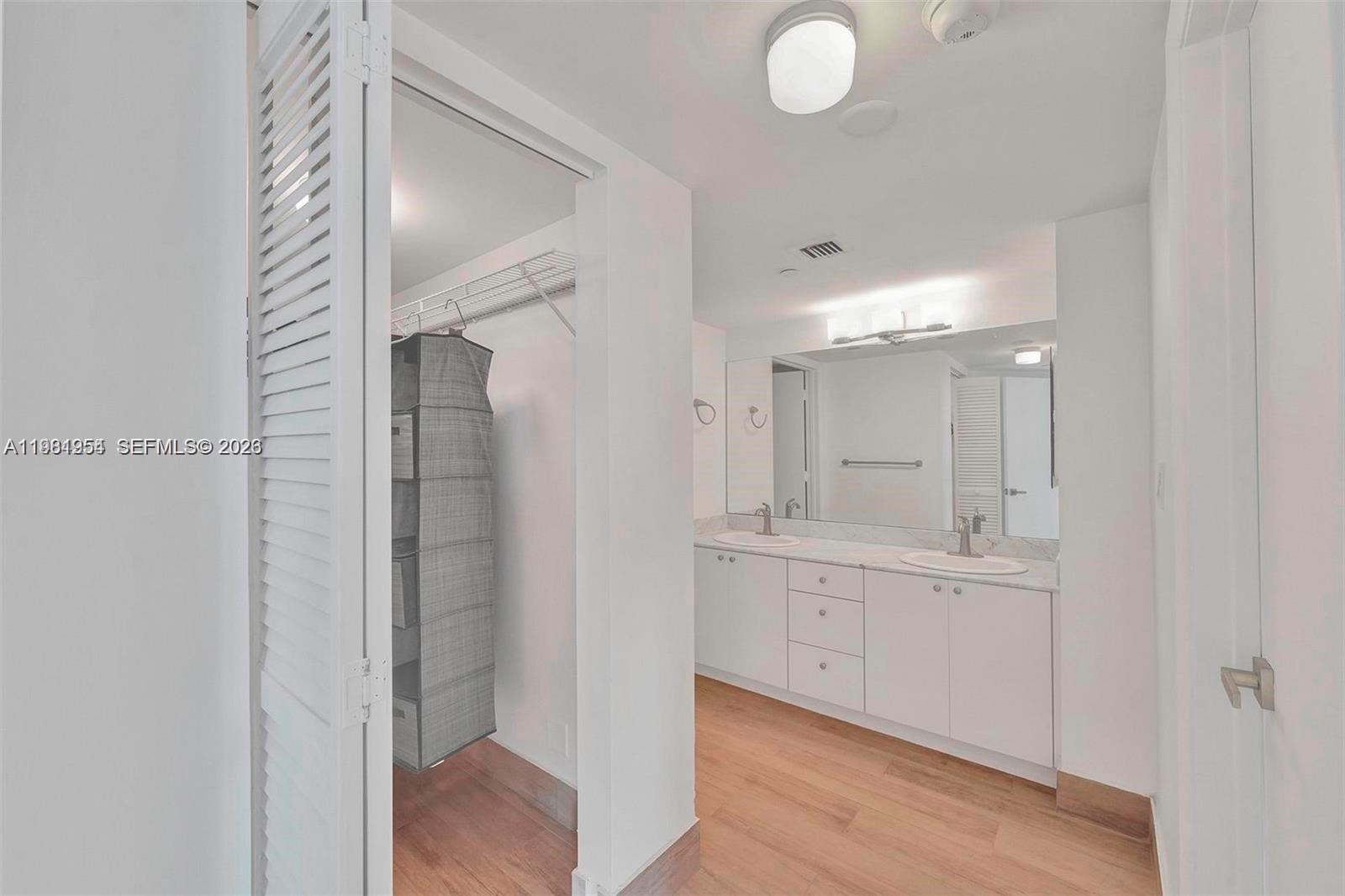 8911 Collins Avenue, Unit 703 Surfside, FL 33154 - Photo 14 of 24 a bathroom with a double vanity sink and mirror