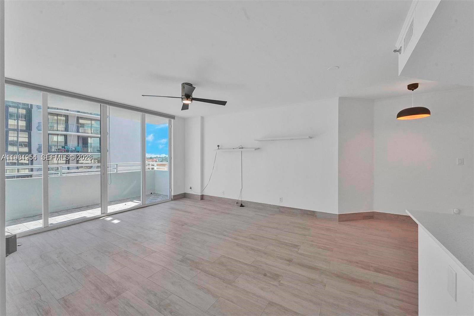 8911 Collins Avenue, Unit 703 Surfside, FL 33154 - Photo 2 of 24 a view of an empty room with glass door