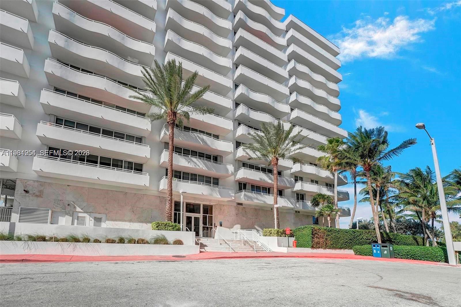 8911 Collins Avenue, Unit 703 Surfside, FL 33154 - Photo 24 of 24 a tall building sitting on the side of a street