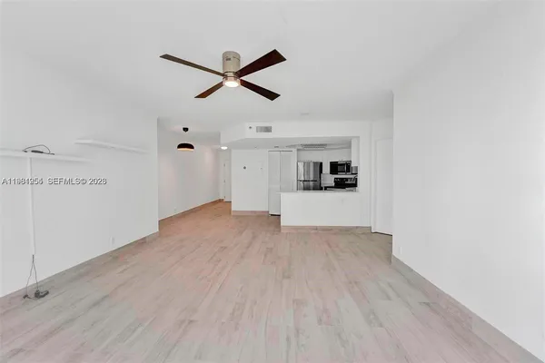 a view of a room with wooden floor and windows