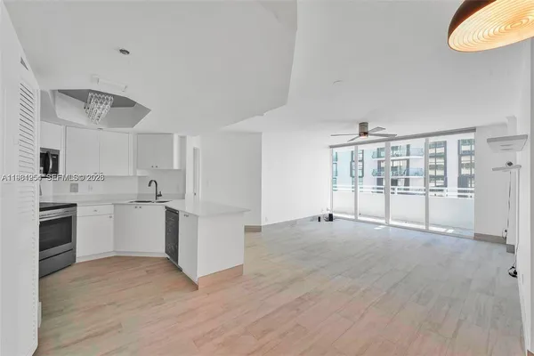 a view of a kitchen with wooden floor and a sink