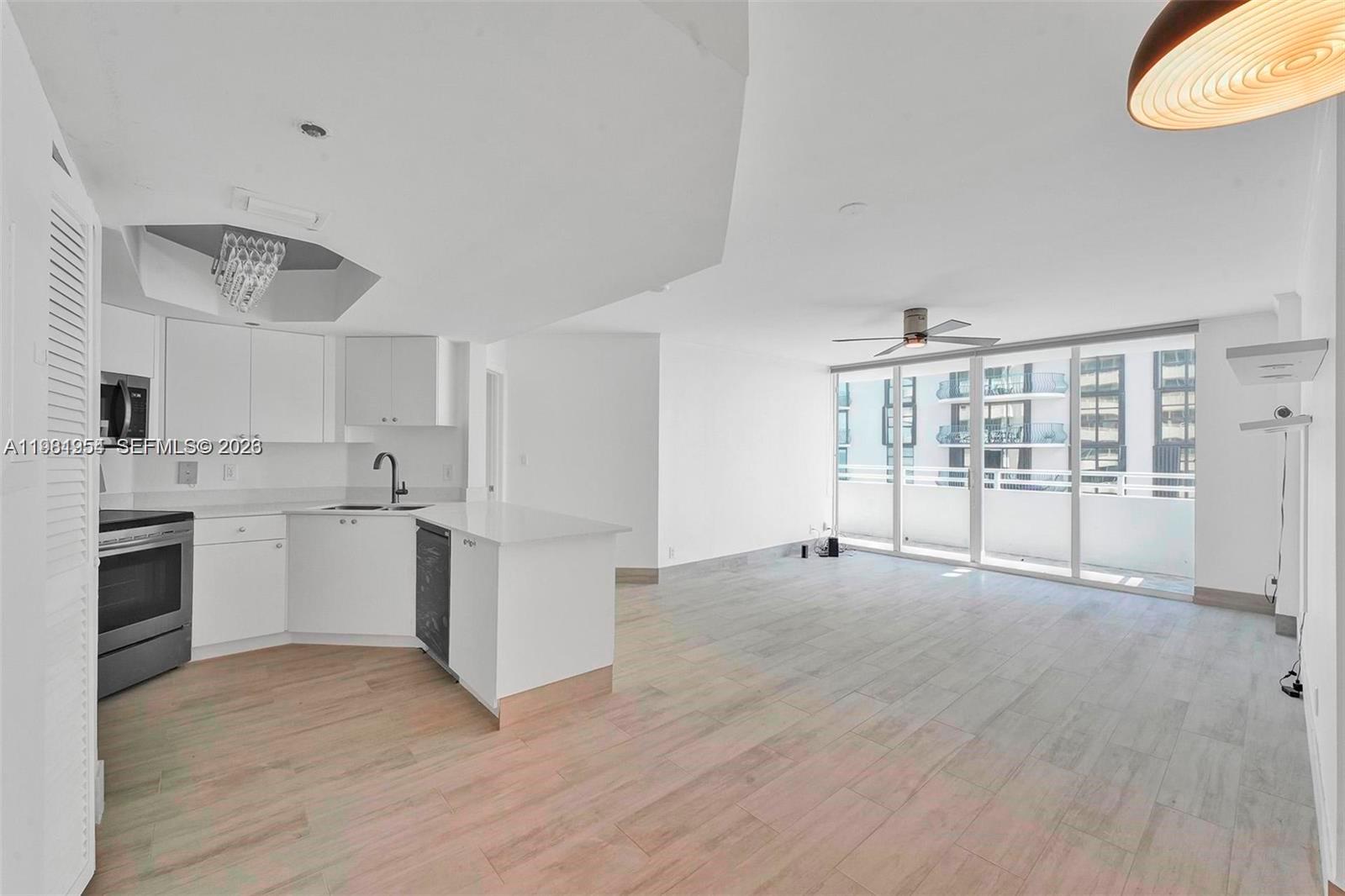 8911 Collins Avenue, Unit 703 Surfside, FL 33154 - Photo 4 of 24 a view of a kitchen with wooden floor and a sink