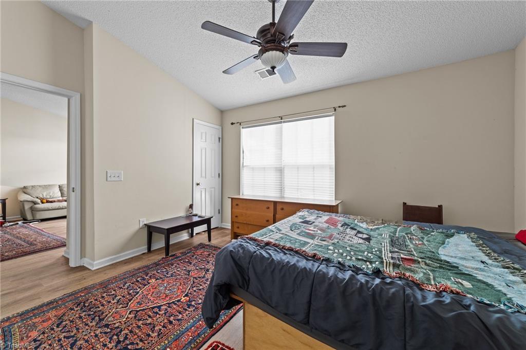 2852 WaterStone Loop High Point, NC 27265 - Photo 17 of 32 Primary bedroom located near the living area.