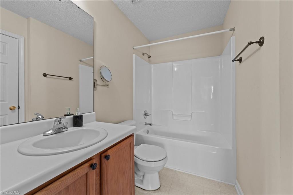 2852 WaterStone Loop High Point, NC 27265 - Photo 9 of 32 Full bathroom with single bowl vanity mirror and shower & tub combo.