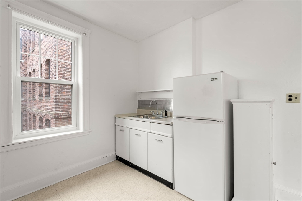 97 Chester Street, Unit 8 Boston, MA 02134 - Photo 6 of 19 a white refrigerator freezer and a dishwasher