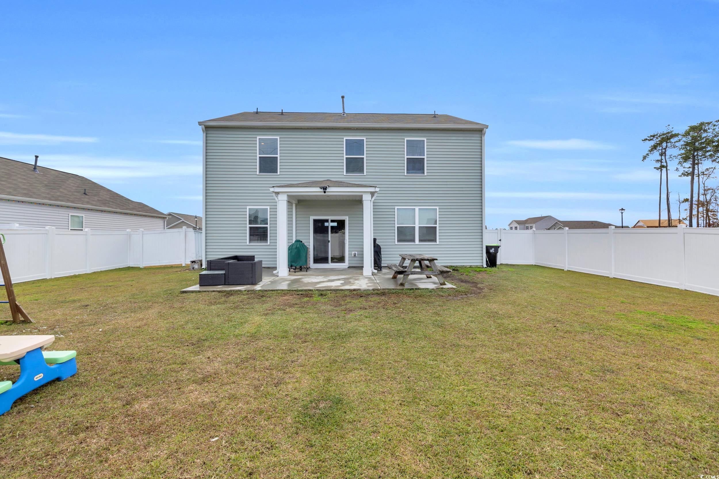 205 Black Pearl Way Myrtle Beach, SC 29588 - Photo 26 of 28 Back of property featuring a patio and a fenced backyard