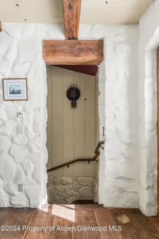 a view of a dining room with furniture a chandelier and wooden floor