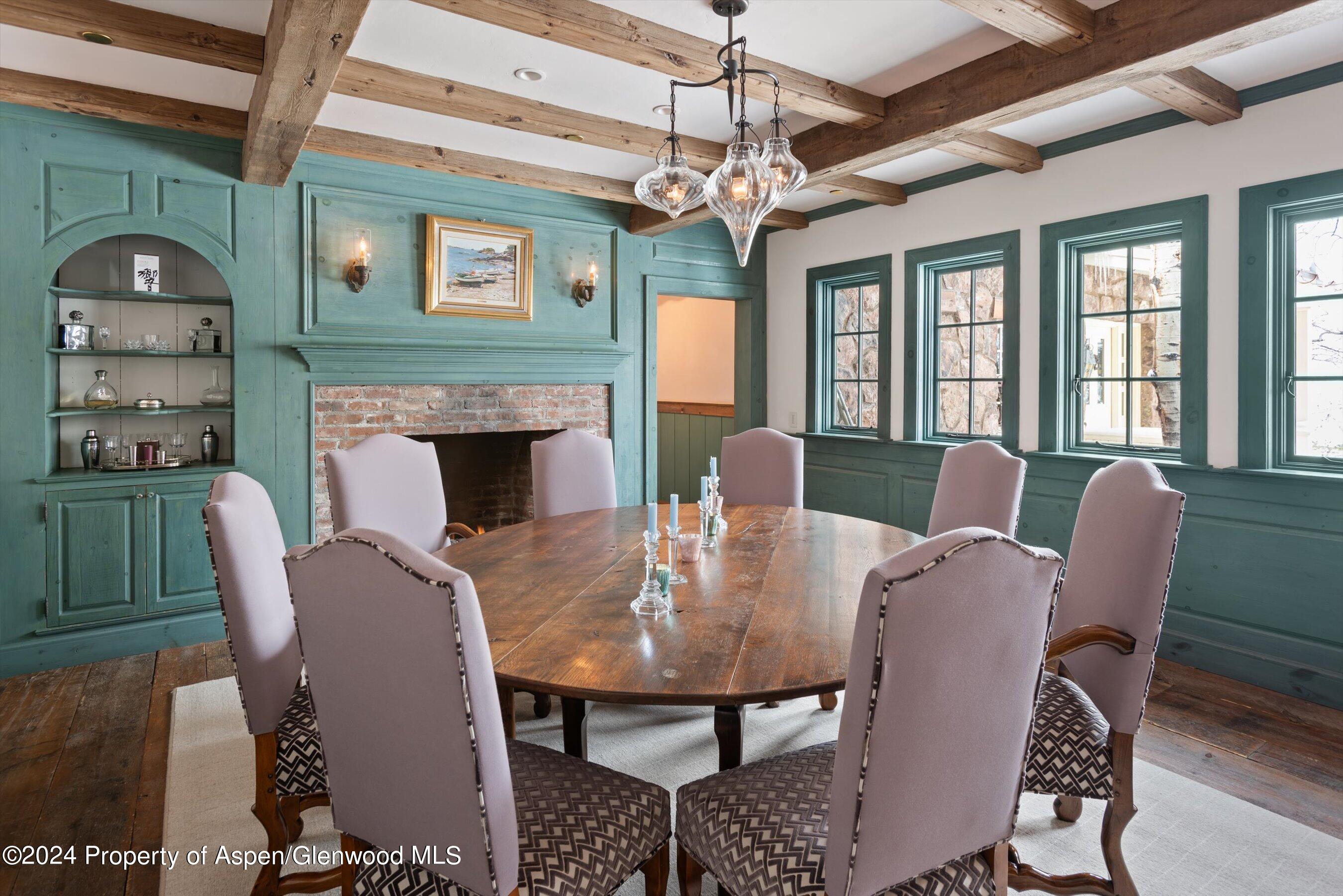 855 Moore Drive Aspen, CO 81611 - Photo 13 of 50 a view of a dining room with furniture a chandelier and wooden floor