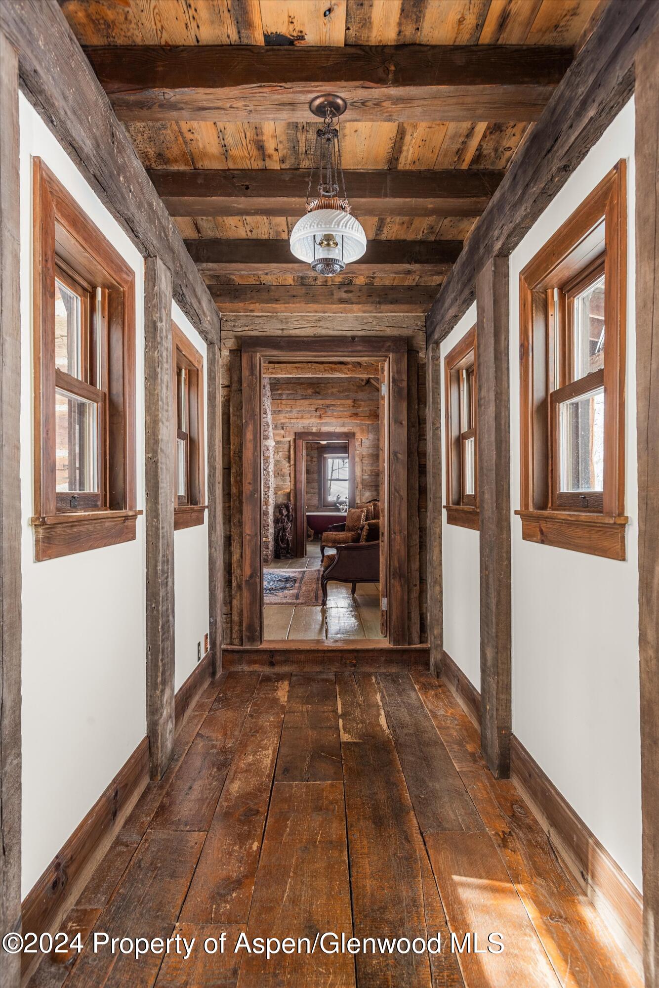 855 Moore Drive Aspen, CO 81611 - Photo 15 of 50 a view of a hallway with a glass door and furniture