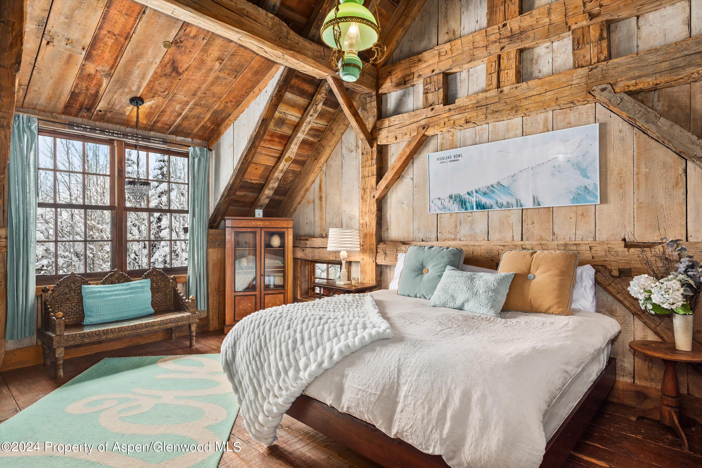 855 Moore Drive Aspen, CO 81611 - Photo 25 of 50 a bed room with a bed and a chandelier