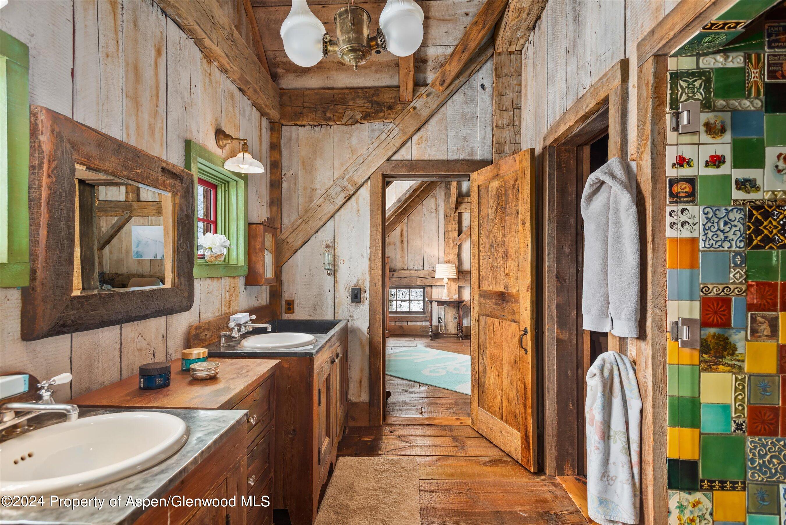 855 Moore Drive Aspen, CO 81611 - Photo 27 of 50 a en suite bathroom with a sink a mirror and a shower