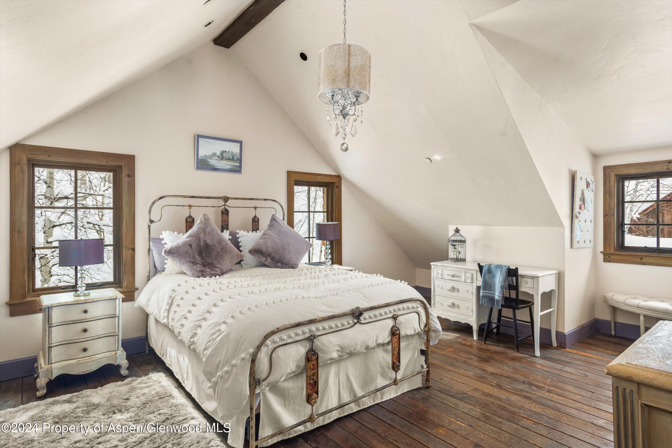 855 Moore Drive Aspen, CO 81611 - Photo 29 of 50 a bedroom with a bed and wooden floor