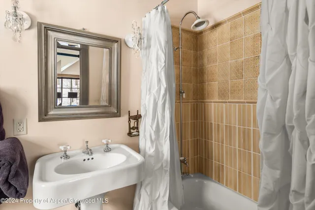 a bedroom with bed and a window