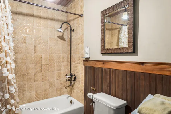 a room with furniture pool table flat screen tv and windows