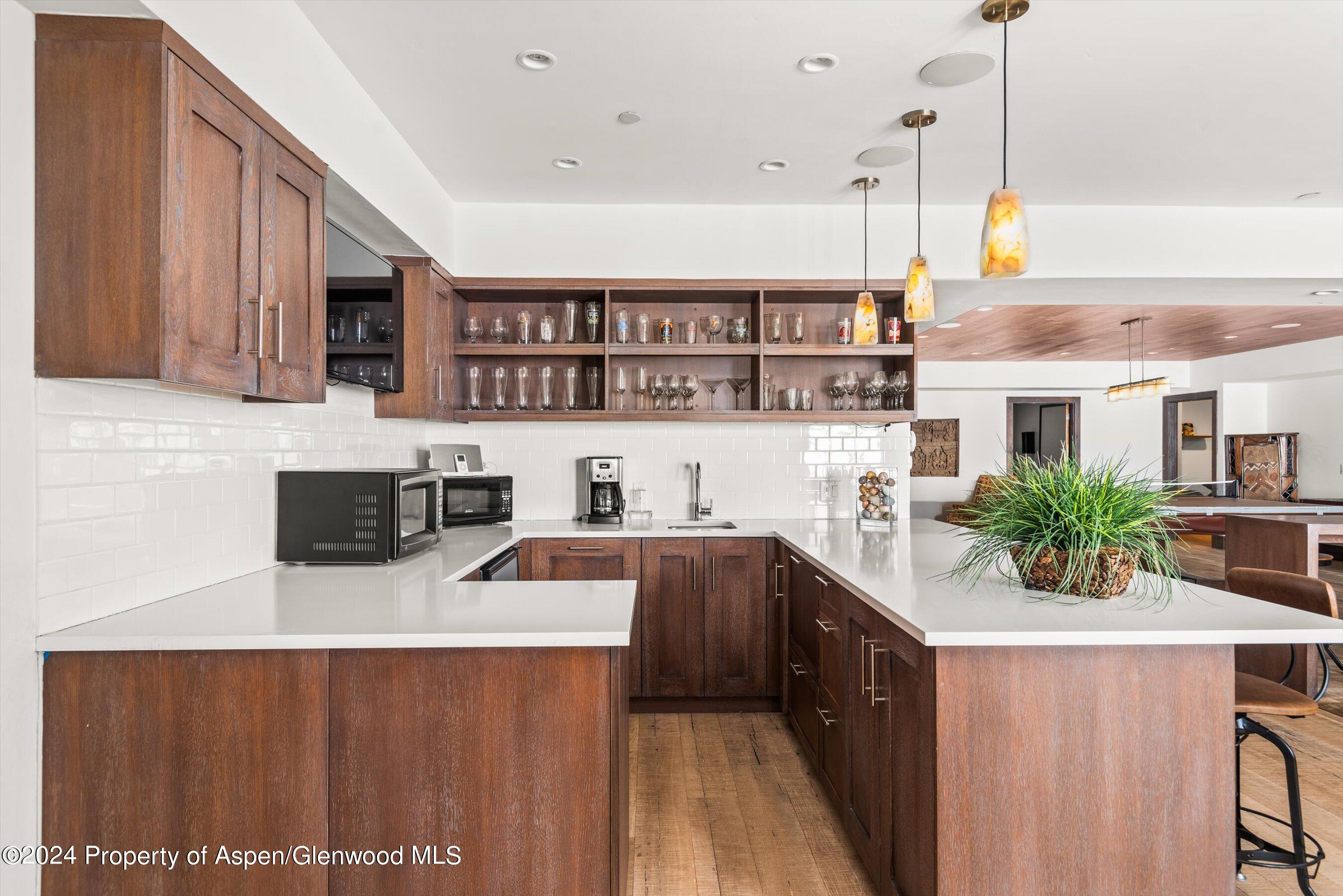 855 Moore Drive Aspen, CO 81611 - Photo 38 of 50 a kitchen with stainless steel appliances a sink a stove top oven a counter space and cabinets