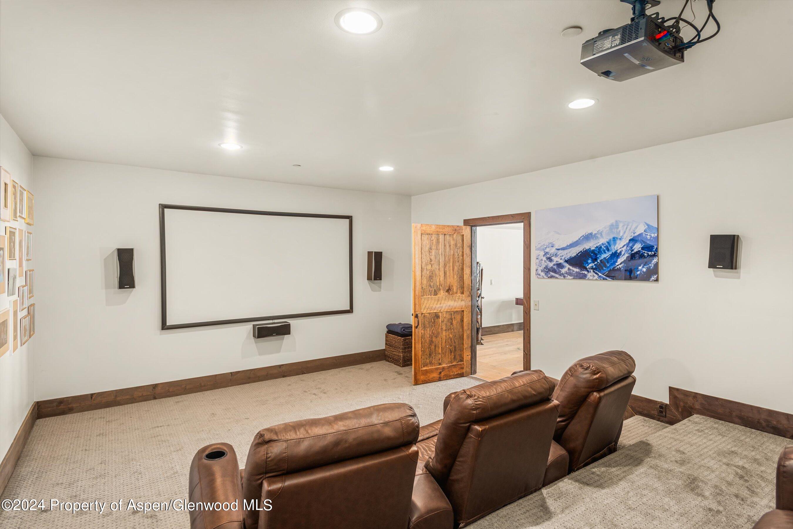 855 Moore Drive Aspen, CO 81611 - Photo 39 of 50 a projector room with couch chairs and a projector screen