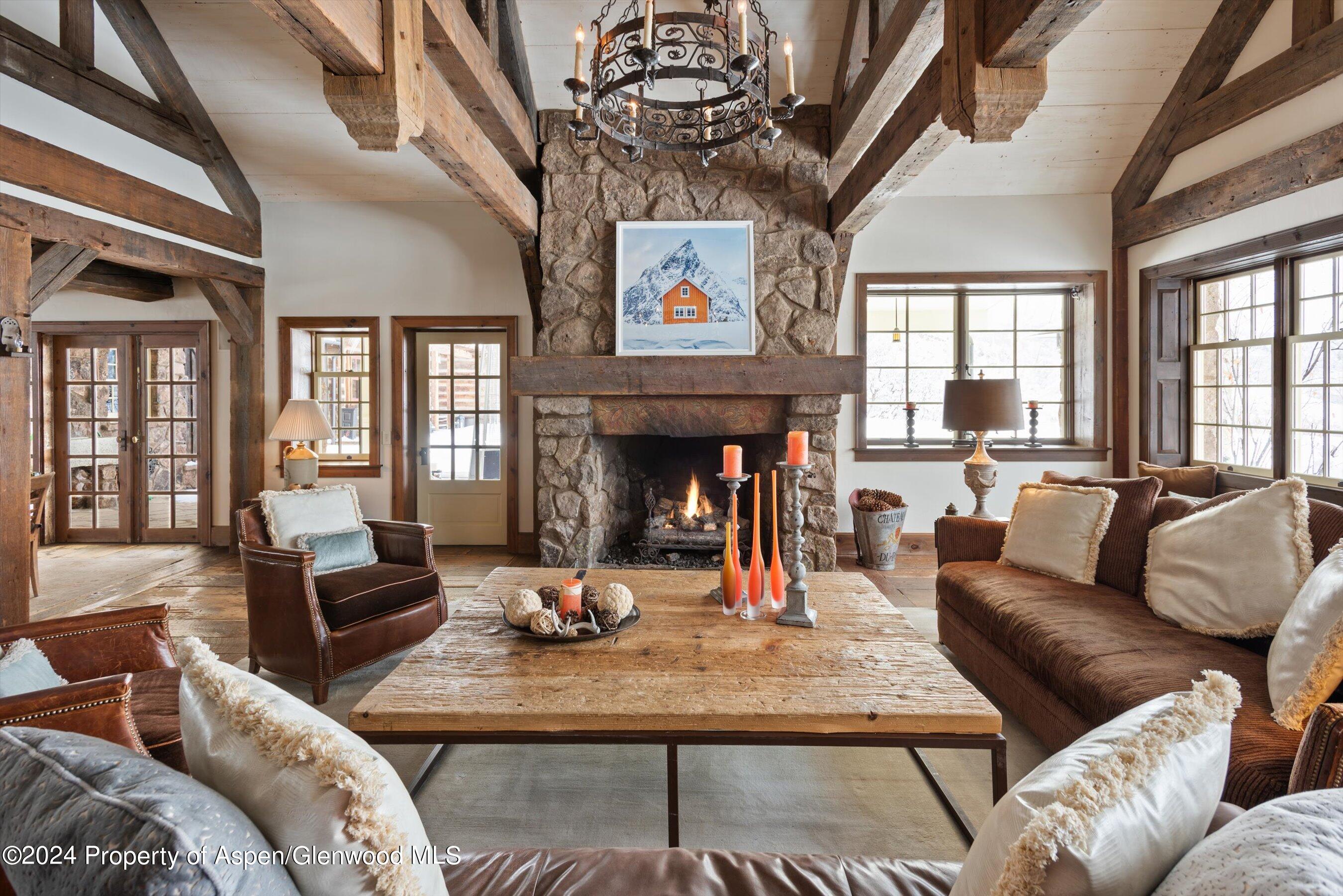 855 Moore Drive Aspen, CO 81611 - Photo 4 of 50 a living room with furniture a fireplace and a chandelier