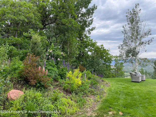 a view of a house with a yard and sitting area