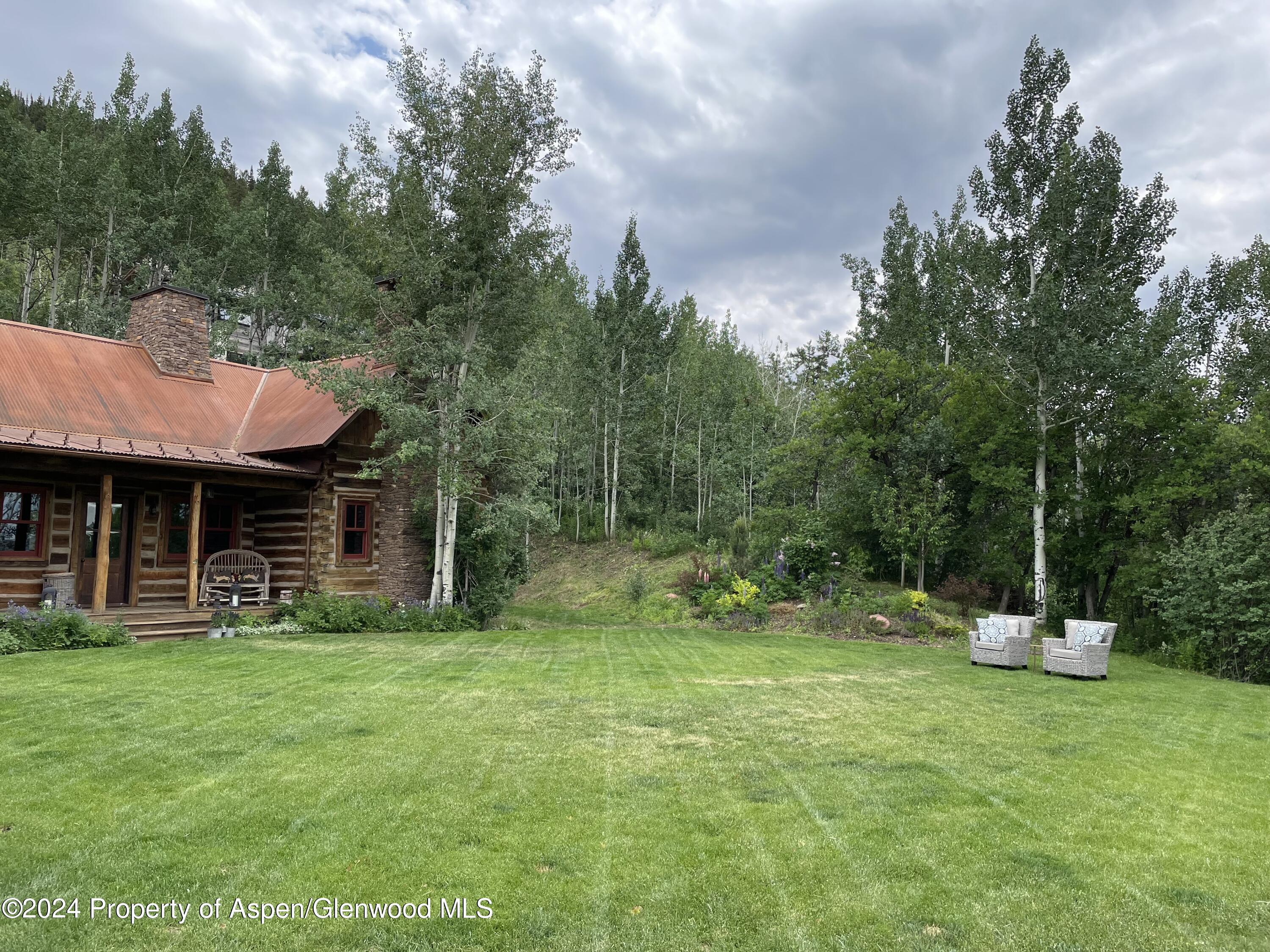 855 Moore Drive Aspen, CO 81611 - Photo 46 of 50 a view of a house with a yard and sitting area