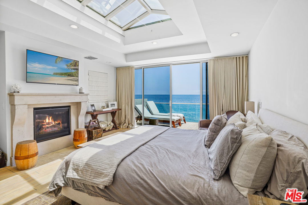 a bedroom with a bed and a fireplace