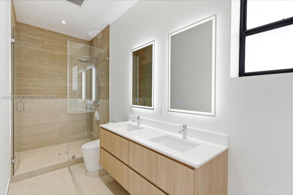 2925 Southwest 36th Avenue Miami, FL 33133 - Photo 25 of 59 a bathroom with a sink a toilet and shower