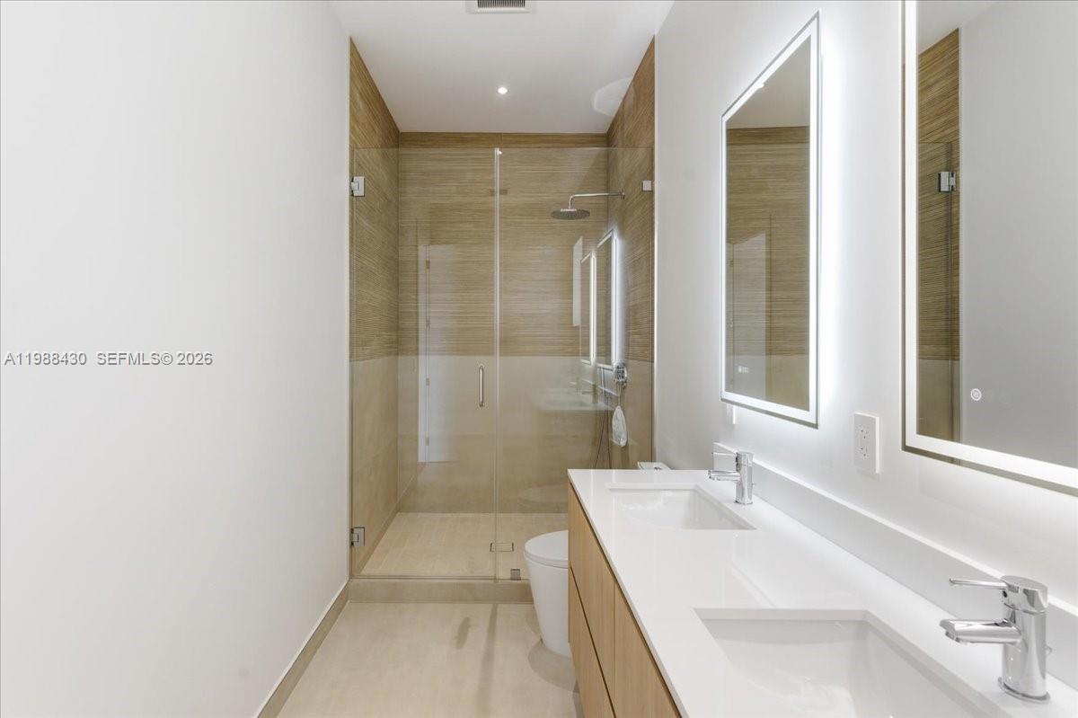 2925 Southwest 36th Avenue Miami, FL 33133 - Photo 26 of 59 a bathroom with a tub sink shower and a mirror