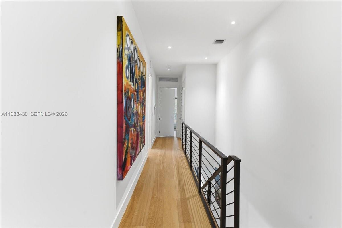 2925 Southwest 36th Avenue Miami, FL 33133 - Photo 28 of 59 a way to bedroom with wooden floor and stairs