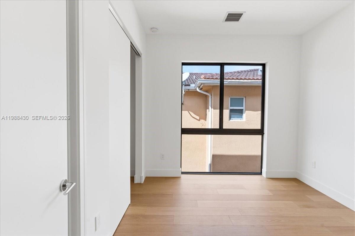 2925 Southwest 36th Avenue Miami, FL 33133 - Photo 34 of 59 a view of a hallway with wooden floor and a large window