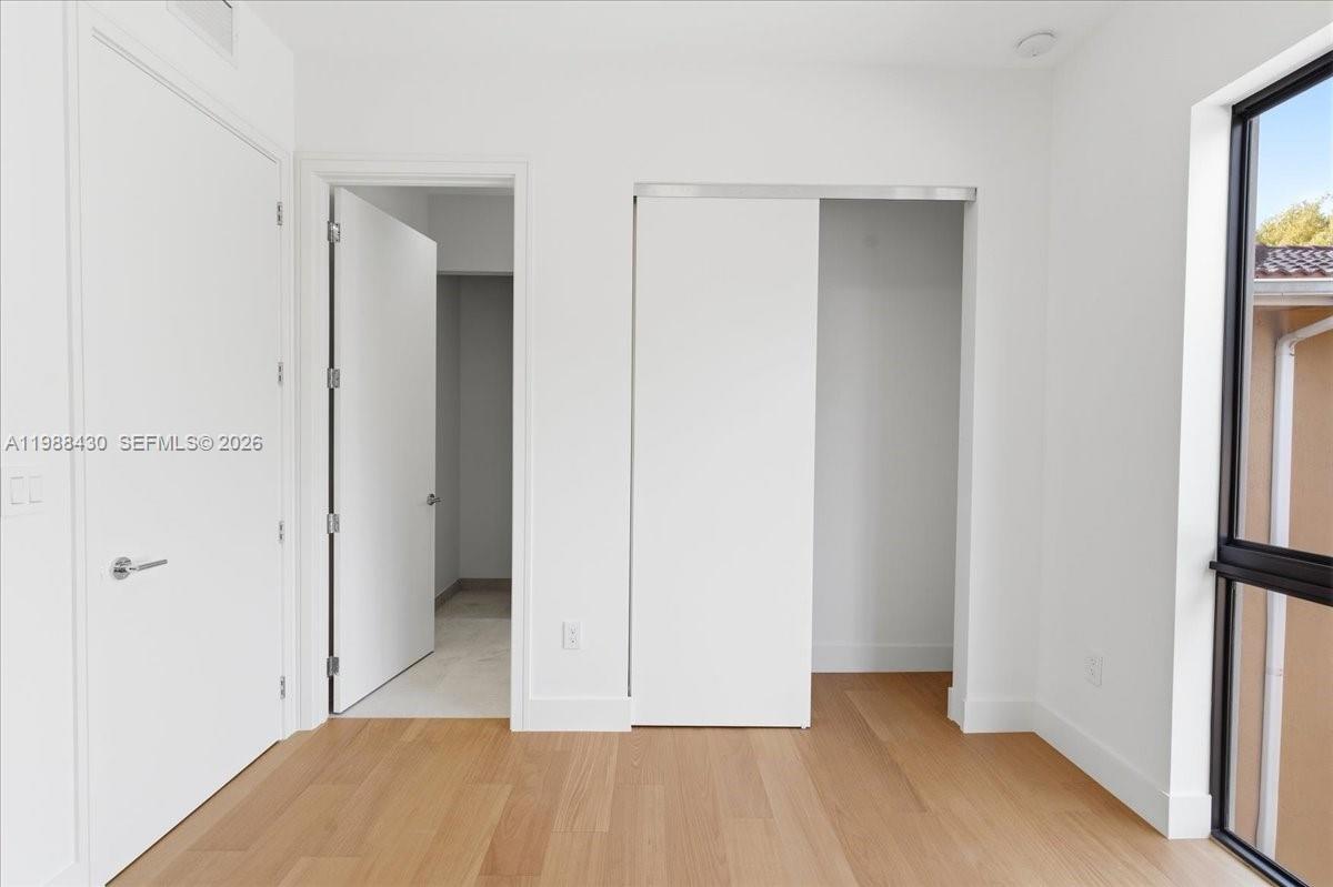 2925 Southwest 36th Avenue Miami, FL 33133 - Photo 35 of 59 a view of a room with wooden floor and a bathroom