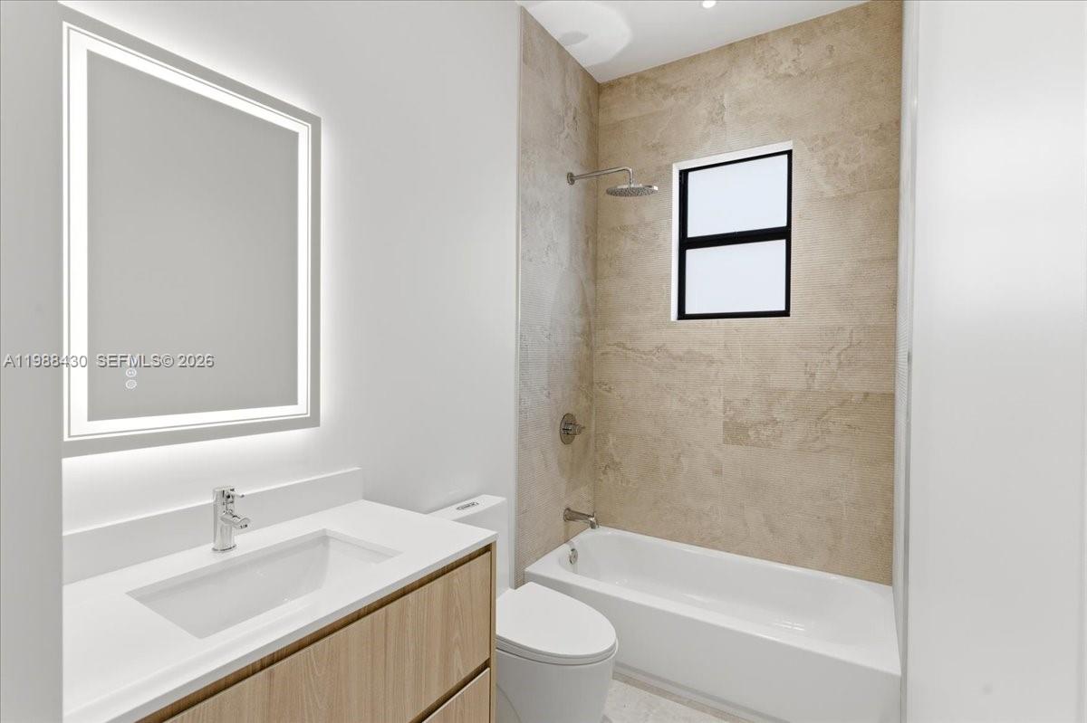 2925 Southwest 36th Avenue Miami, FL 33133 - Photo 36 of 59 a bathroom with a granite countertop sink toilet and shower