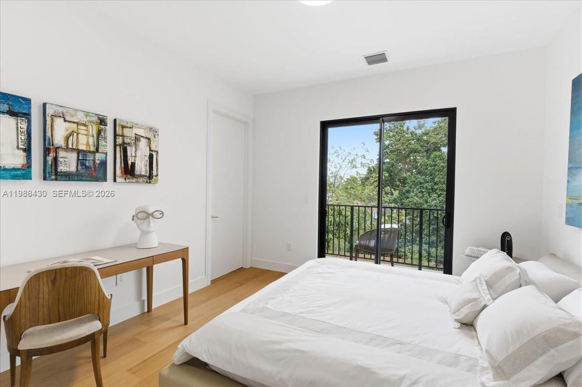 2925 Southwest 36th Avenue Miami, FL 33133 - Photo 39 of 59 a bedroom with a bed and wooden floor