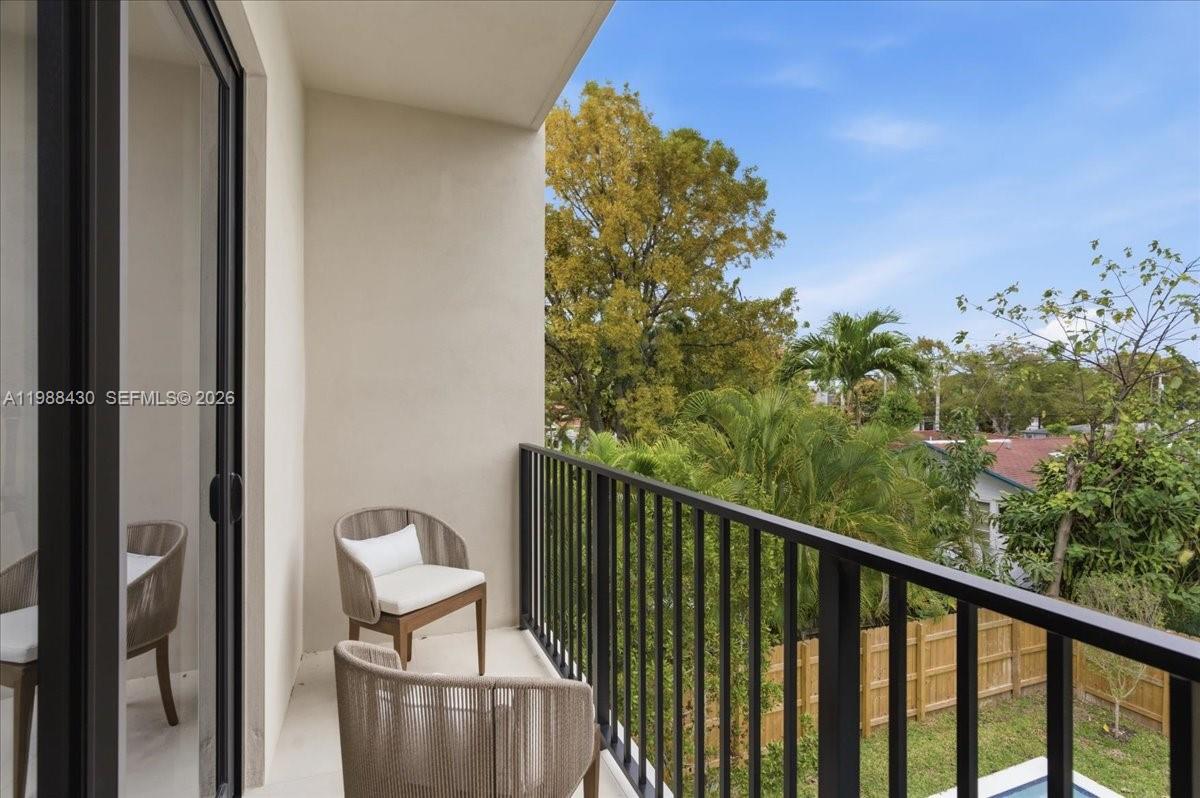 2925 Southwest 36th Avenue Miami, FL 33133 - Photo 44 of 59 a view of a balcony with wooden fence and floor
