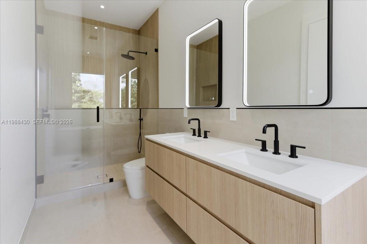 2925 Southwest 36th Avenue Miami, FL 33133 - Photo 49 of 59 a bathroom with a sink and a mirror