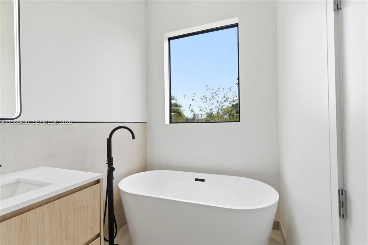 2925 Southwest 36th Avenue Miami, FL 33133 - Photo 51 of 59 a white bath tub sitting in a bathroom