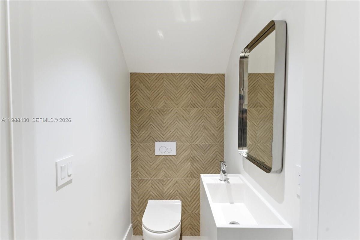 2925 Southwest 36th Avenue Miami, FL 33133 - Photo 58 of 59 a bathroom with a sink a toilet and shower