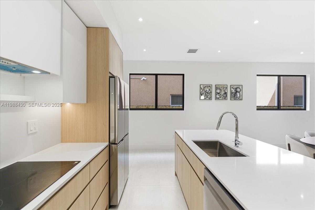 2925 Southwest 36th Avenue Miami, FL 33133 - Photo 6 of 59 a kitchen with a sink and a refrigerator
