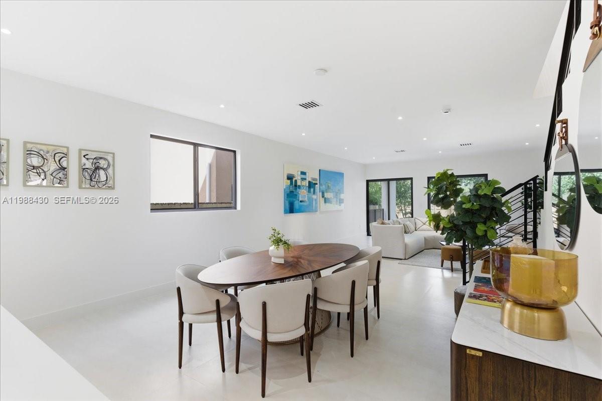 2925 Southwest 36th Avenue Miami, FL 33133 - Photo 7 of 59 a view of a dining room with furniture and a potted plant