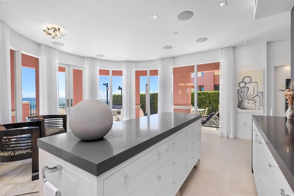 2140 North Ocean Boulevard, Unit V Fort Lauderdale, FL 33305 - Photo 12 of 63 a living room with furniture and large windows