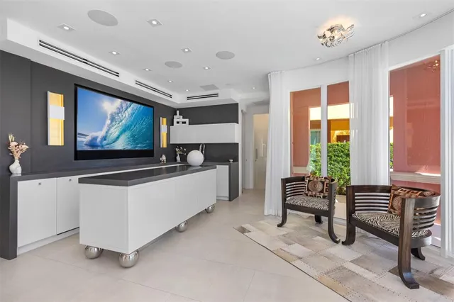 a white toilet sitting next to a bathroom sink and a mirror