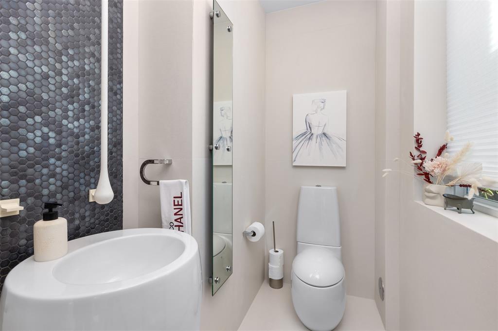 2140 North Ocean Boulevard, Unit V Fort Lauderdale, FL 33305 - Photo 16 of 63 a white toilet sitting next to a bathroom sink