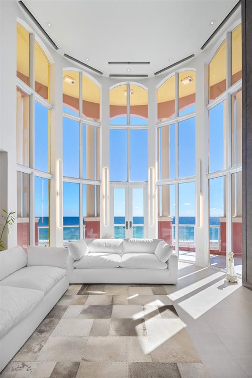 2140 North Ocean Boulevard, Unit V Fort Lauderdale, FL 33305 - Photo 19 of 63 a living room filled with furniture and large windows