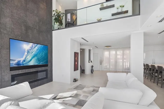 a hallway with painting on the wall and a potted plant